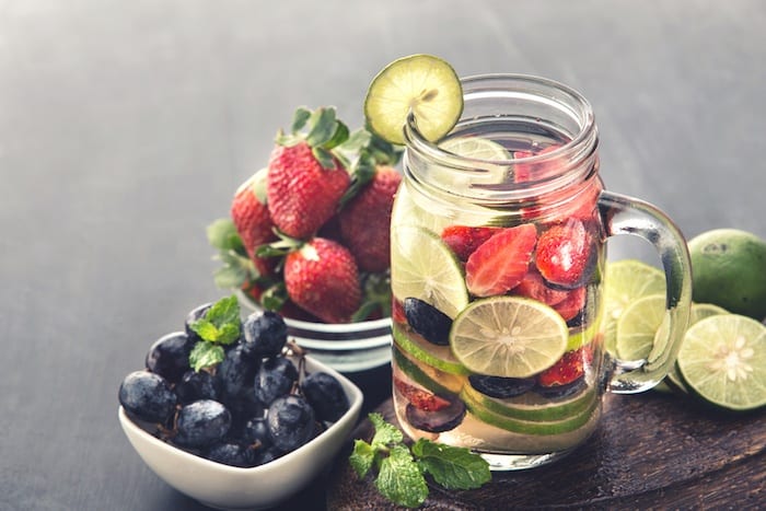 Detox drink with fruits in glass jar