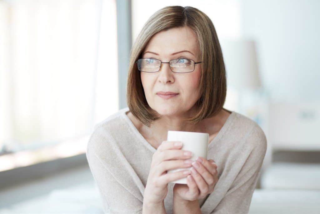 Mature woman drinking cup of tea