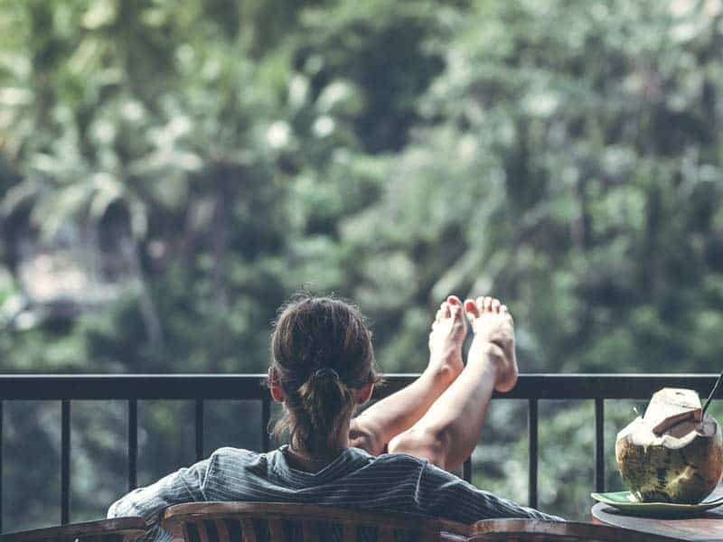 Back of woman relaxing by the balcony