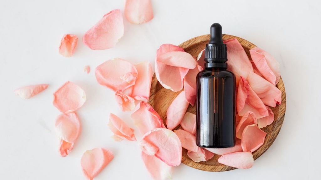 rose essential oil background image with petals