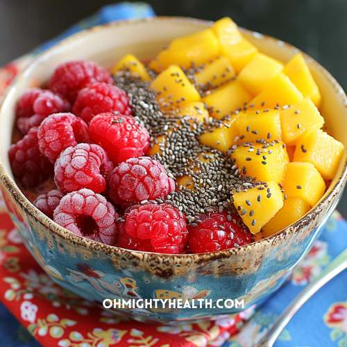 Raspberry, peach and mango bowl with chia seeds. 