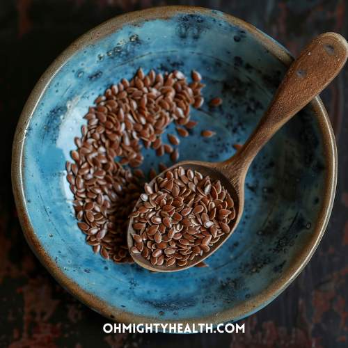 Wooden spoon with flaxseed in bowl.