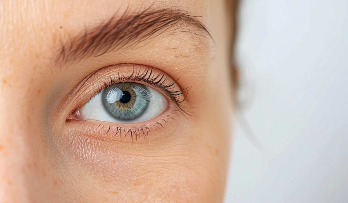 Side of white woman face, we see the eye and healthy under-eye skin