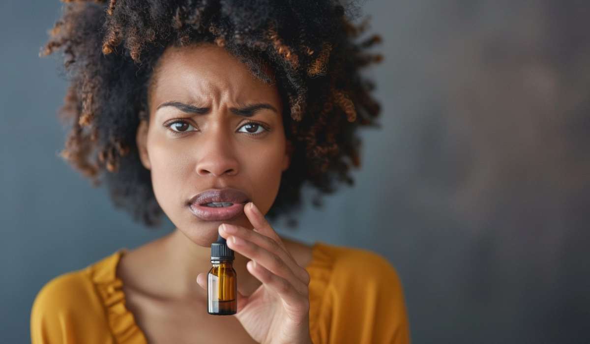 Worried woman holding essential oil bottle.